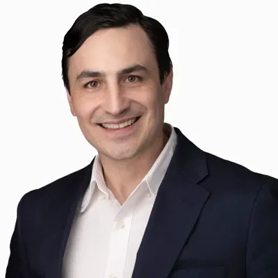 Professional headshot of man in navy suit