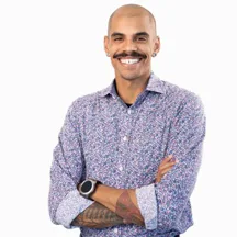 Professional headshot of bald man with mustache in floral shirt