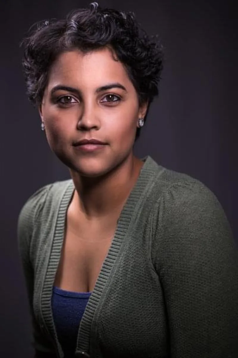 Professional headshot of woman with curly hair